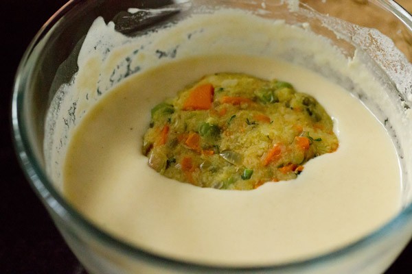 veg patties being dipped in the batter