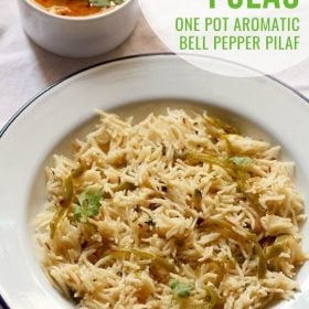 top shot of capsicum rice in a dark blue rimmed white plate with text layovers