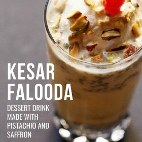 kesar pista falooda garnished with chopped nuts, glazed cherry and served in a tall glass with text layovers.
