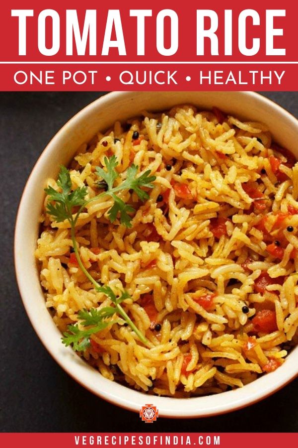 Tomato Rice with a coriander leaf sprig served in a cream bowl on a black board