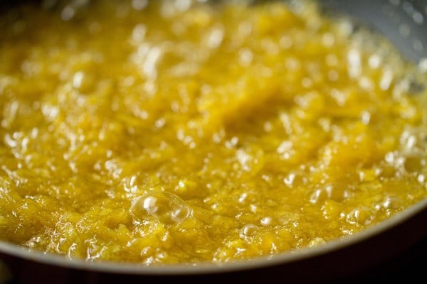 cooking the mango mixture in the pan. 