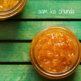 aam chunda kept in a glass jar on a green board with text layovers.
