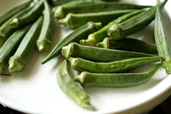 rinsed and dried okra (bhindi) on a plate. 