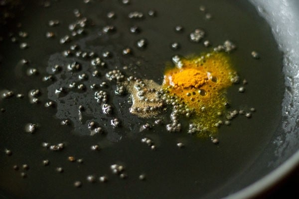 turmeric powder and asafoetida added to the pan. 