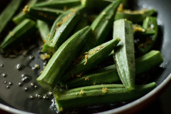 stuffed okra pieces added in the pan. 