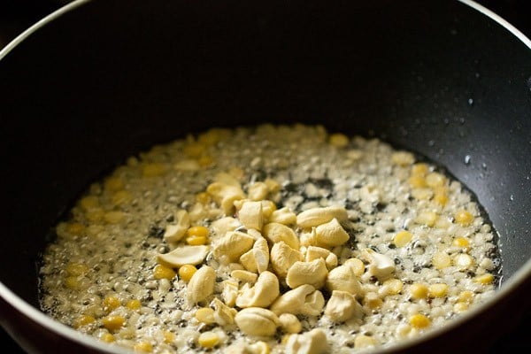 chopped cashews added in the black pan. 