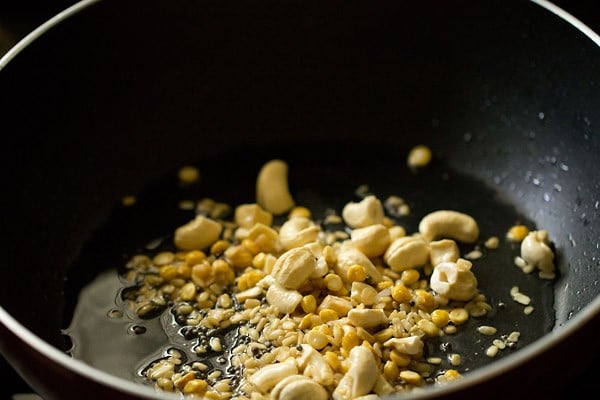 frying cashews and lentils in pan. 