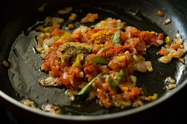 spice powders added to the onion-tomato mixture., 