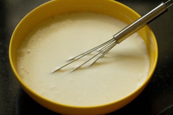 water added to curd mixture and whisked well. 