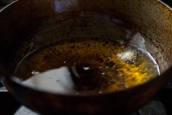 tiny vada mixture getting fried in oil