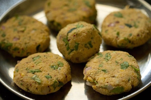 shaped masala vada patties on a steel plate