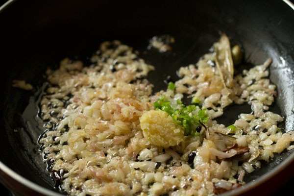 ginger-garlic paste and green chili added to onions