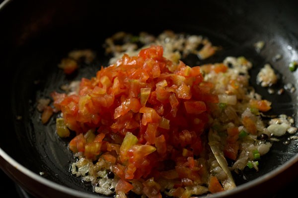 chopped tomatoes added to the pan