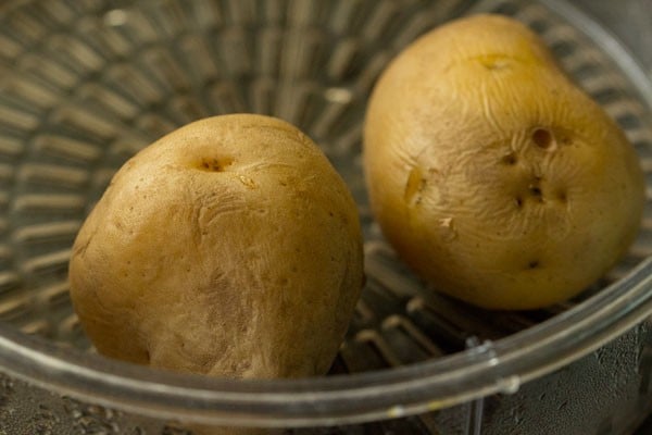steamed two potatoes in a pan.