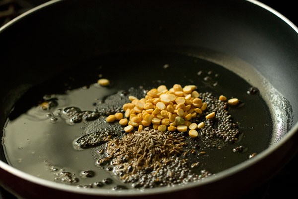 more spices and lentils in pan.