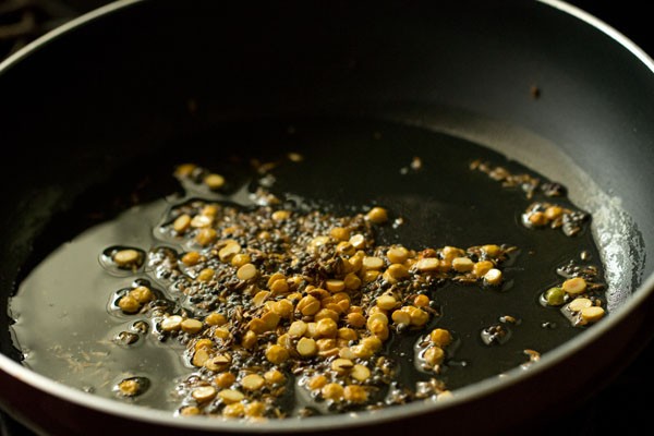 frying lentils and spices in pan