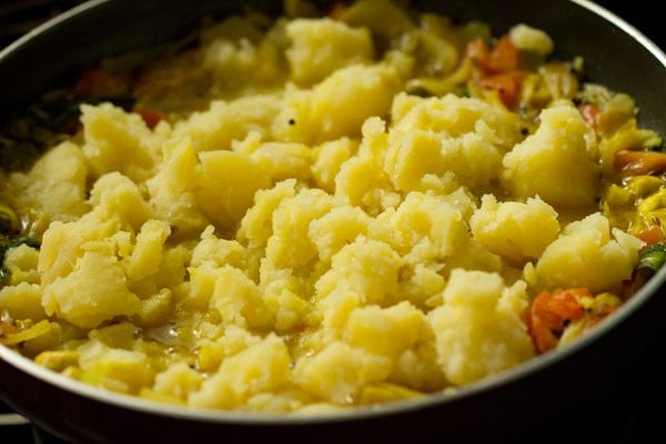 potatoes on the curry in pan.