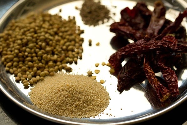 spices kept on a steel plate for aloo kurma. 