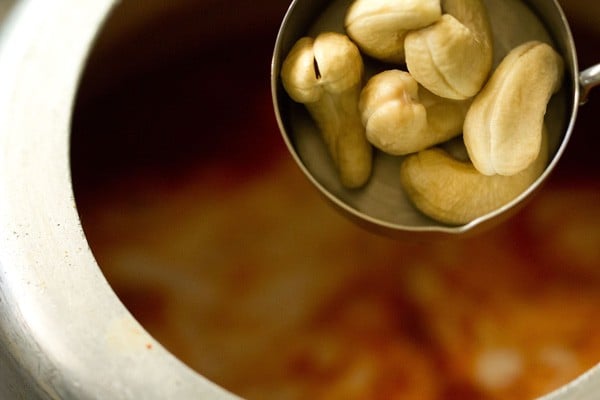 adding cashews to the curry. 