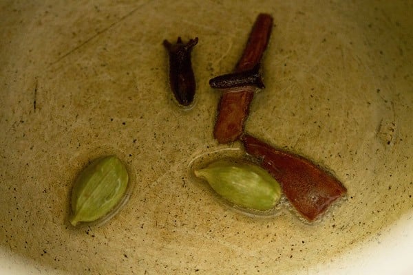 whole spices added to hot oil in a pressure cooker. 