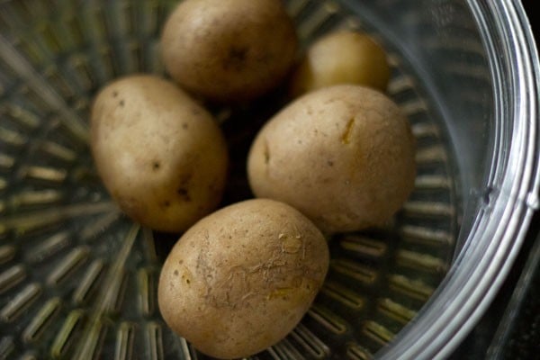 boiling potatoes for rajasthani mirchi vada. 