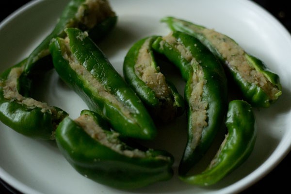 green chilies stuffed with the prepared potato mixture. 