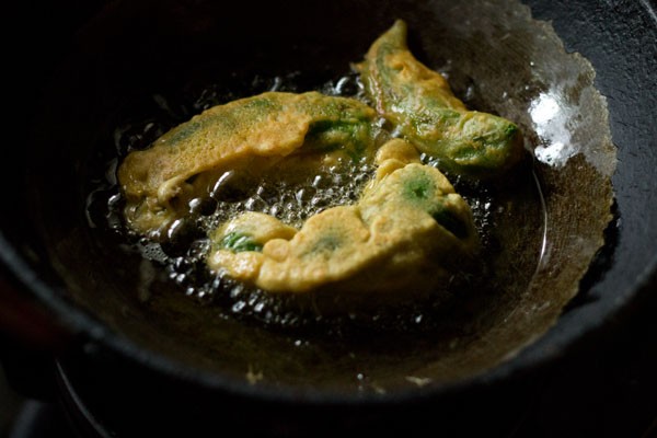 frying stuffed mirchi vada in hot oil. 