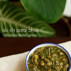 colocasia leaves recipe served in a blue rimmed bowl.