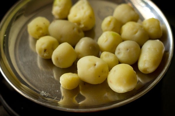 boiled and peeled baby potatoes. 