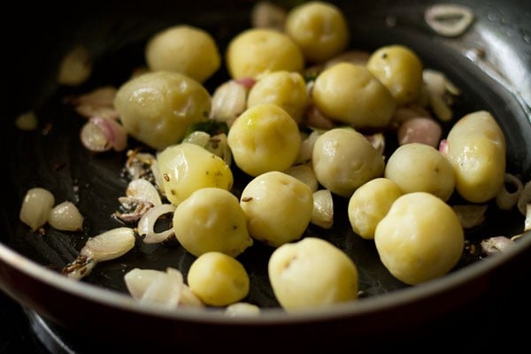 peeled baby potatoes added to the pan. 