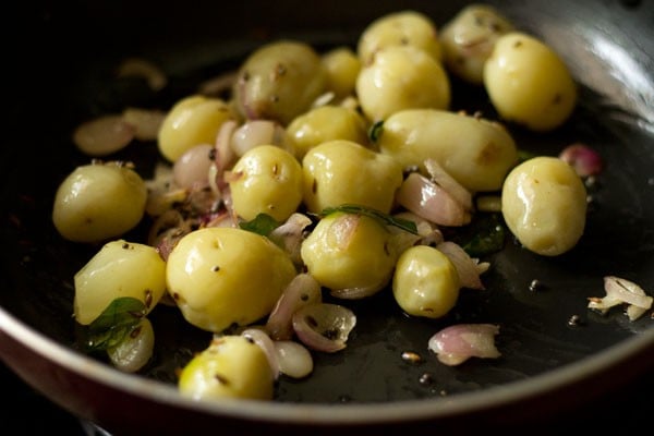 baby potatoes stirred well with the onions and spices.