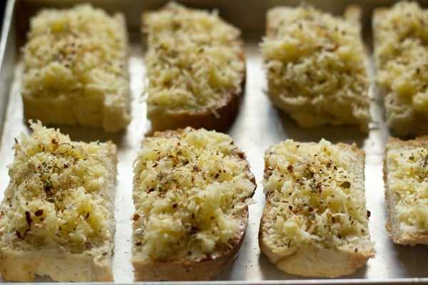 cheese garlic breads placed on a baking tray. 