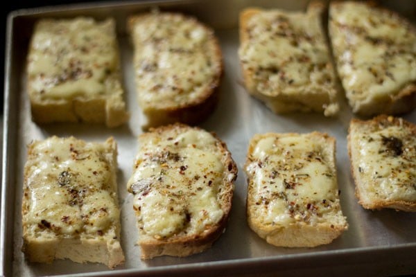 baked cheese garlic bread on the tray. 