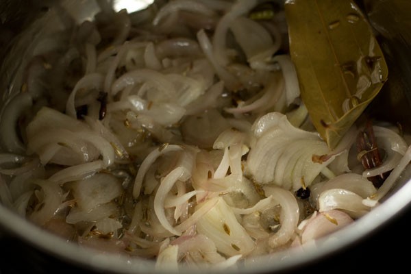 Sautéed onions and spices in pan