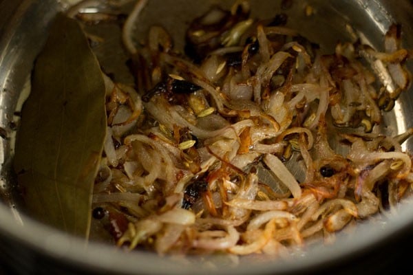Browned onions and spices in pan