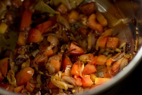 Sauteed onions and tomatoes in pan