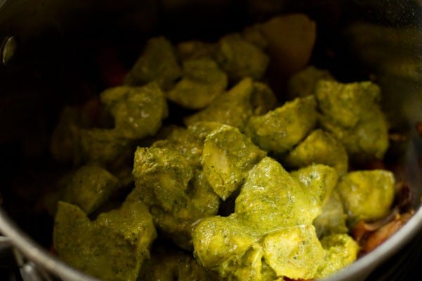 Mushrooms in green marinade in pan