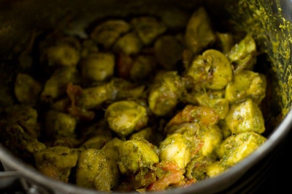 Sautéed Mushrooms in green marinade in pan