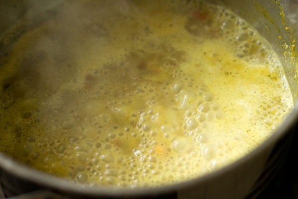 Mushroom biryani mixture simmering in pan