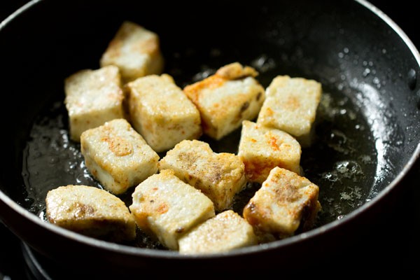 when the oil is medium hot, place the paneer cubes in the pan.