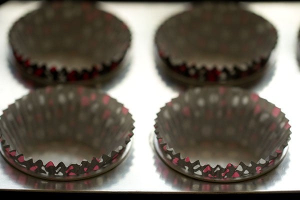 Close up shot of paper muffin liners in muffin tin.