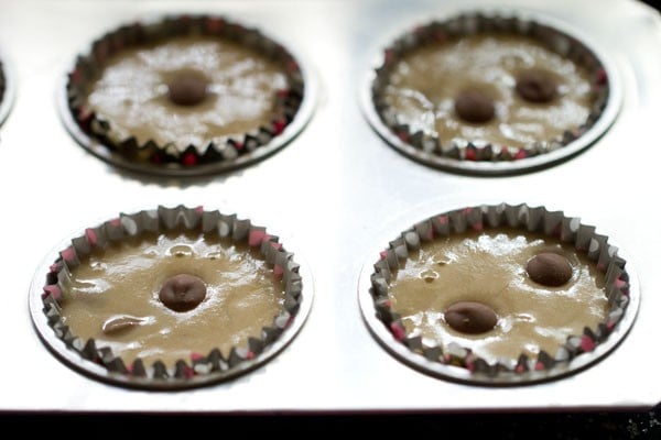 Chocolate chip muffins batter poured into muffin tin for baking.