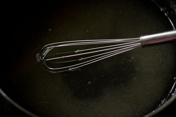 water in pan with wired whisk inside