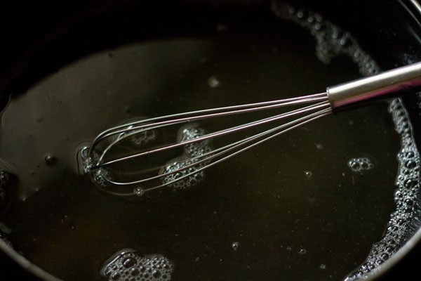 mixing sugar with wired whisk