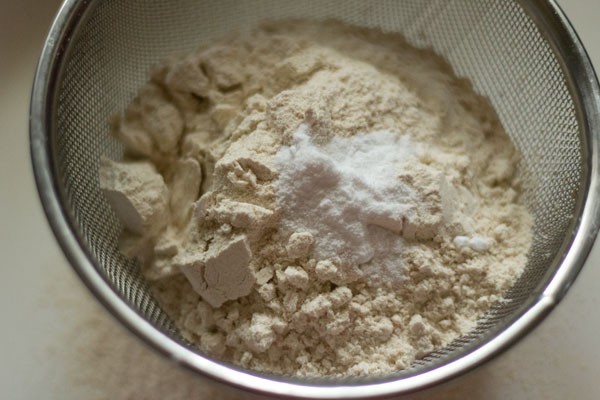 whole wheat flour and baking powder in a sieve