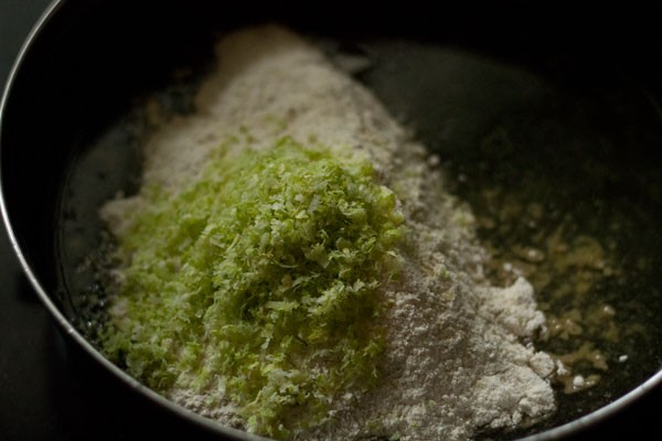 lemon zest, flour on top of the lemon solution in the black bowl