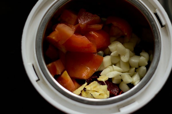 chopped tomatoes, chopped ginger and chopped garlic added to grinder jar. 