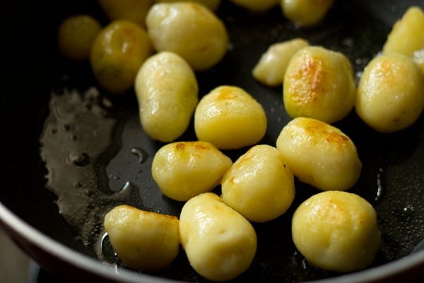 pan frying baby potatoes till crisp and golden.
