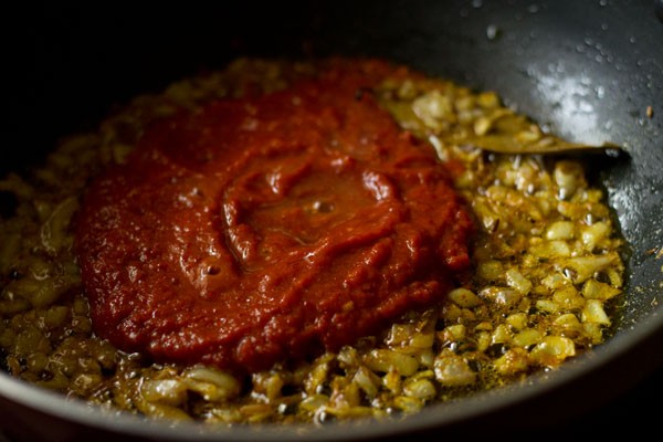 prepared masala paste added to spiced onions. 