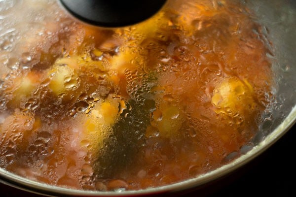 simmering lasaniya batata in covered pan. 